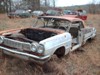 more old cars in the junkyard